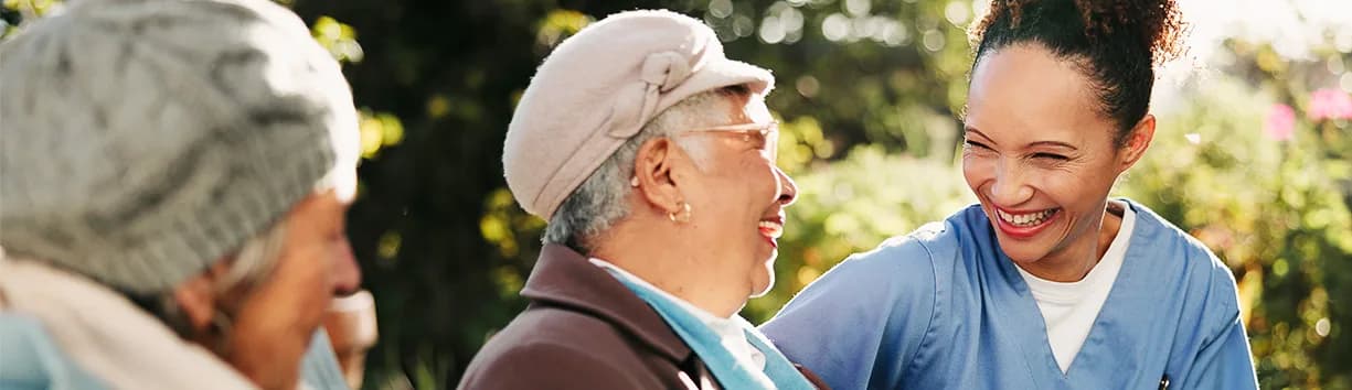 Caregivers sharing a joyful moment with elderly clients