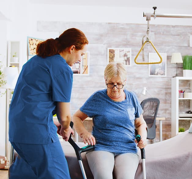 Caregiver helping elderly man at home